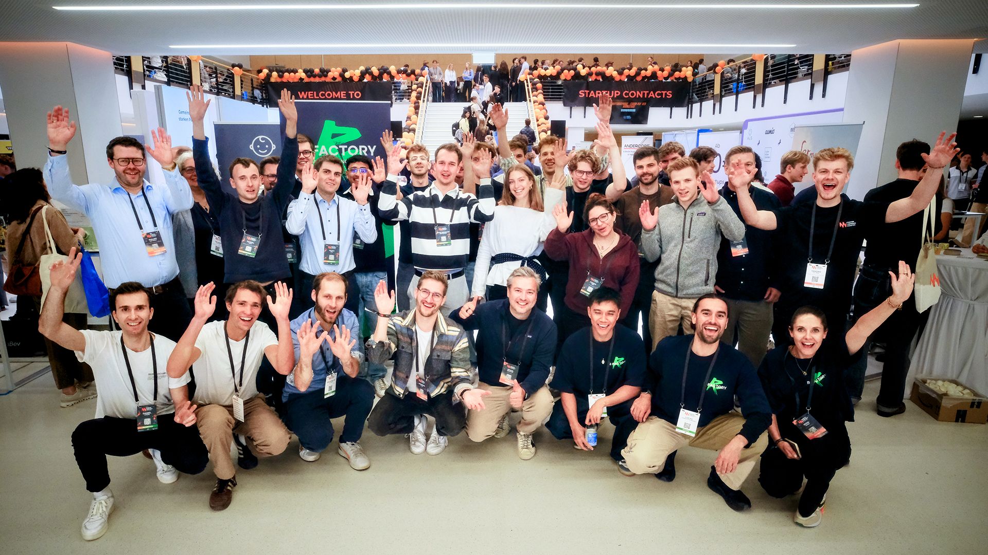 Group photo of the R-Factory team in an event hall