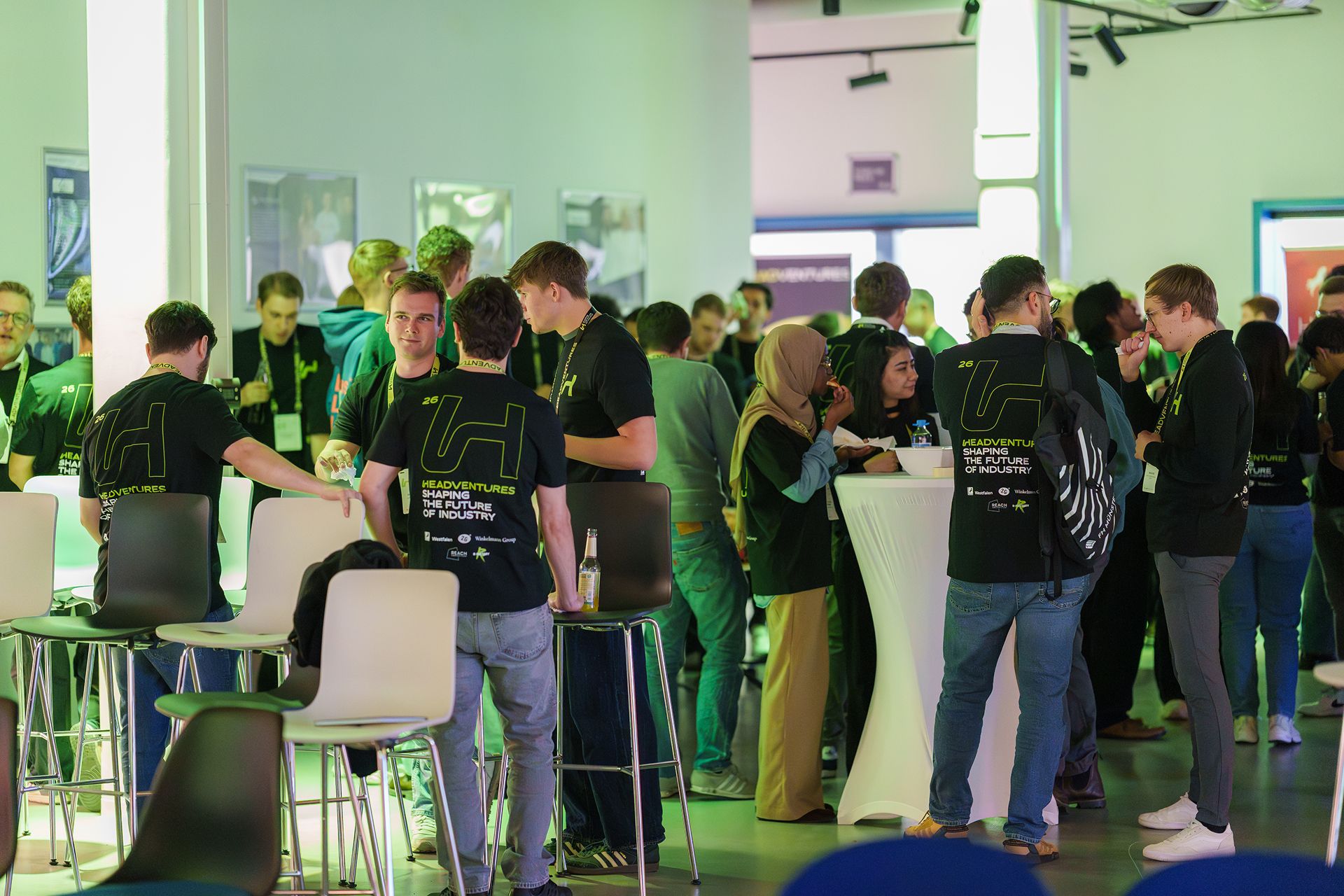 Networking among founders at bar tables at the Headventures startup event