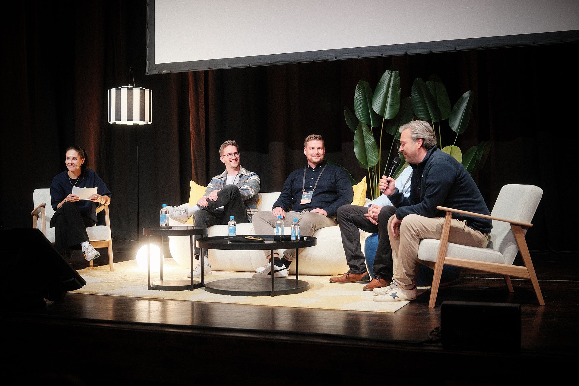 Panel discussion with four guests on stage at a startup conference